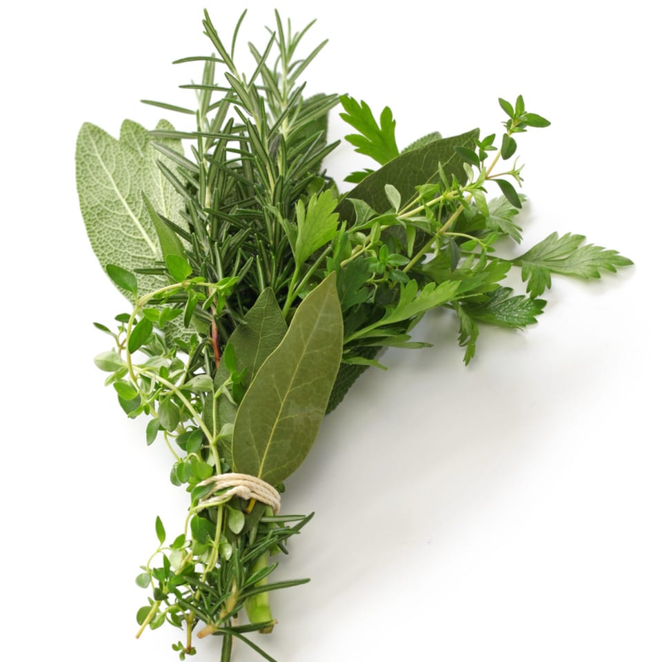 Fresh Italian herbs, including rosemary, sage, thyme, parsley, and bay leaves, tied together.