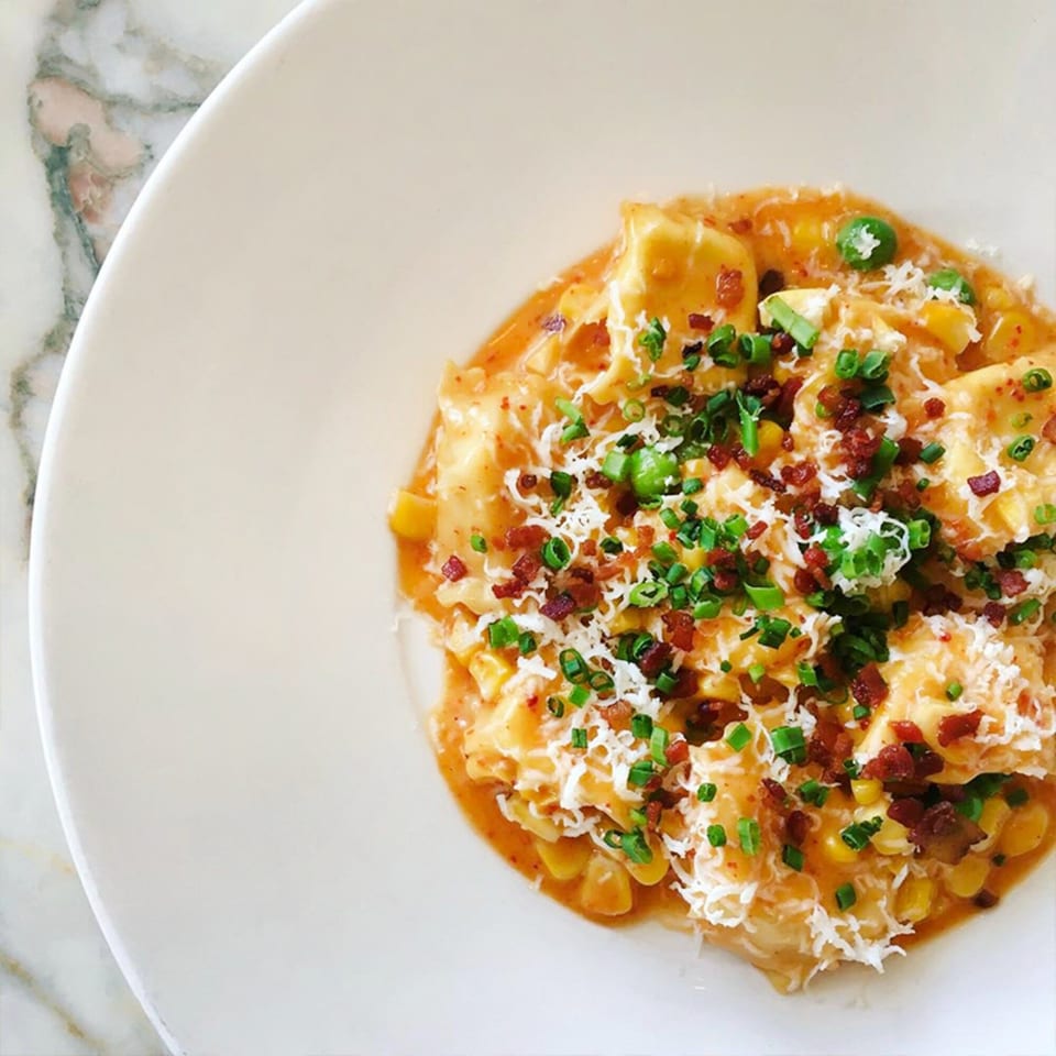 Rosario's Trattoria & Pizzeria's ravioli dish, topped with bacon, chives, and parmesan cheese.