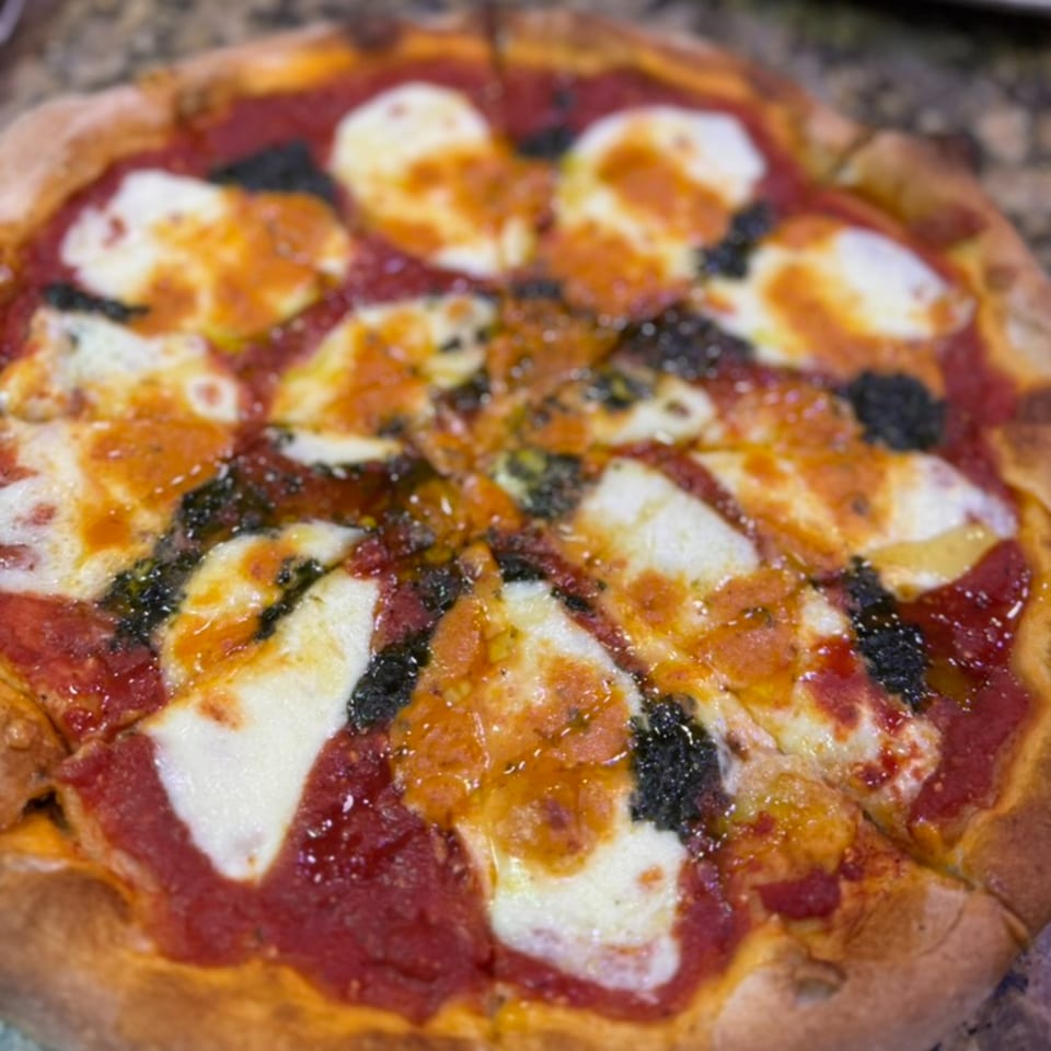 Rosario's Trattoria & Pizzeria's Margherita pizza with fresh mozzarella, tomato sauce, and basil pesto.
