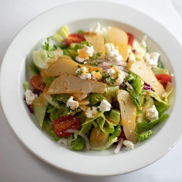 Rosario's Trattoria & Pizzeria's fresh Italian salad with lettuce, tomatoes, pears, and feta cheese.