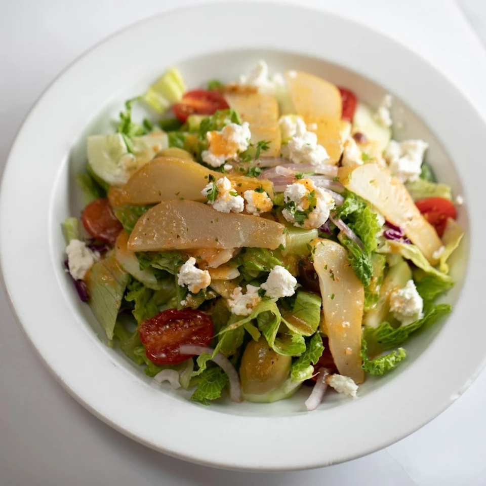 Rosario's Trattoria & Pizzeria's fresh Italian salad with lettuce, tomatoes, pears, and feta cheese.