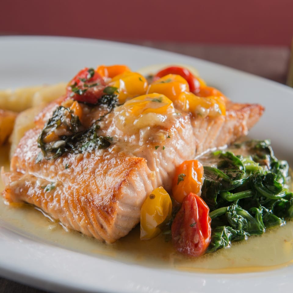 Rosario's Trattoria & Pizzeria's salmon with cherry tomatoes, spinach, and a light sauce.